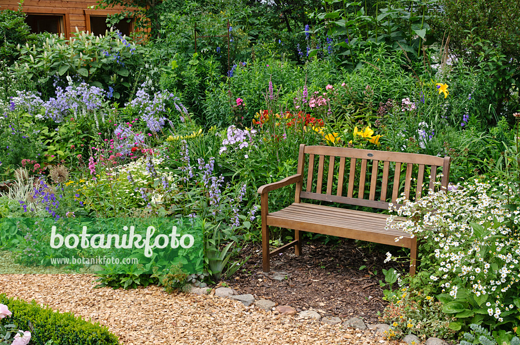 474094 - Bench in a perennial garden