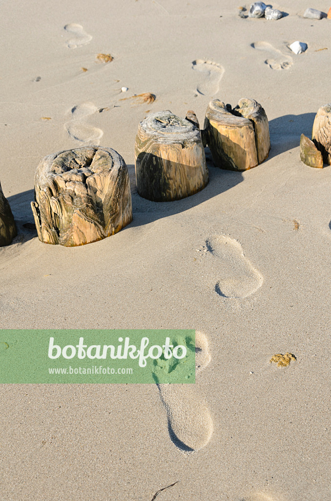 534327 - Breakwater with footprints in the sand