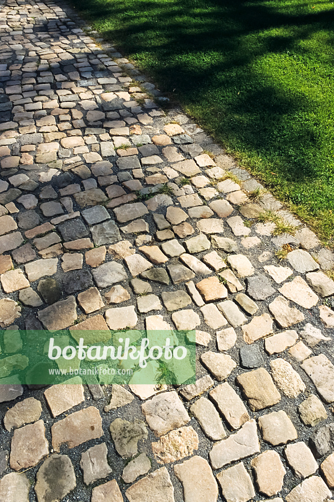 394070 - Cobblestones made of rough blocks in a park