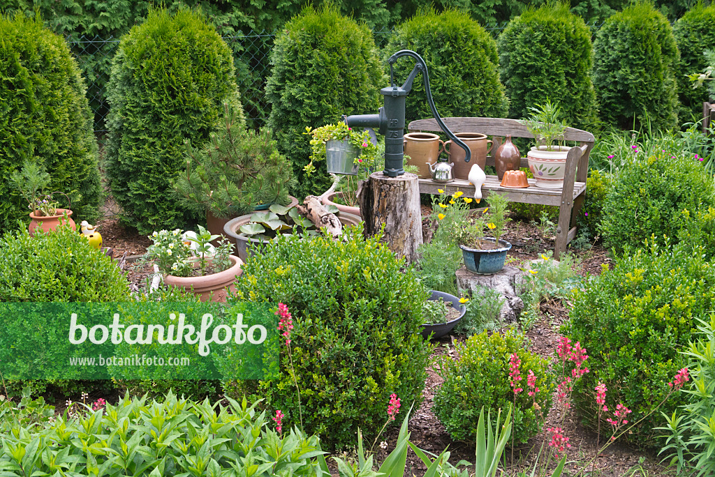 608138 - Garden bench with flower pots and beam pump