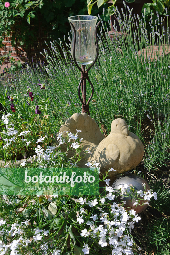 475263 - Garden decoration with terracotta bird and candle