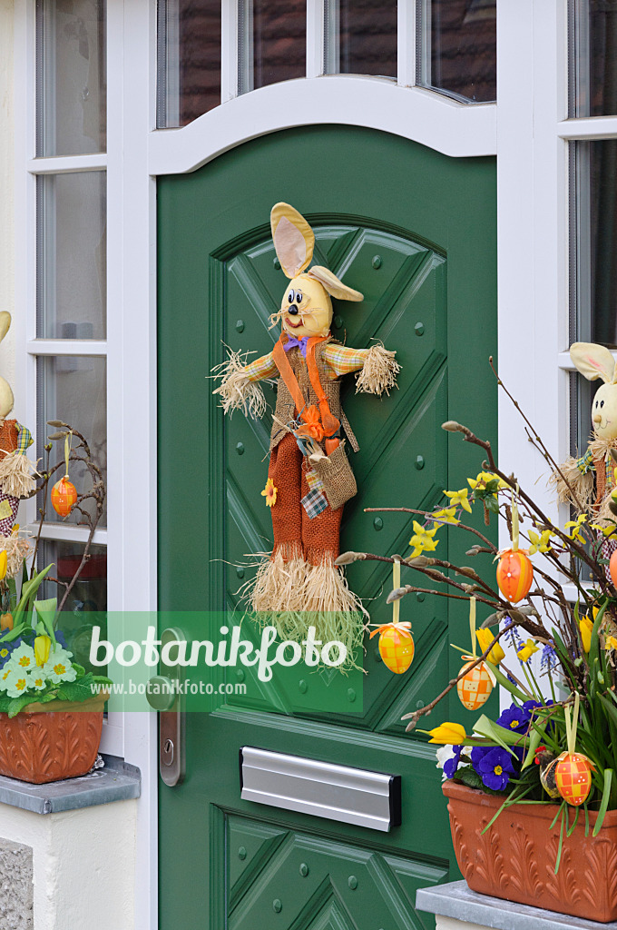 470067 - House entrance with Easter decoration and spring flowers