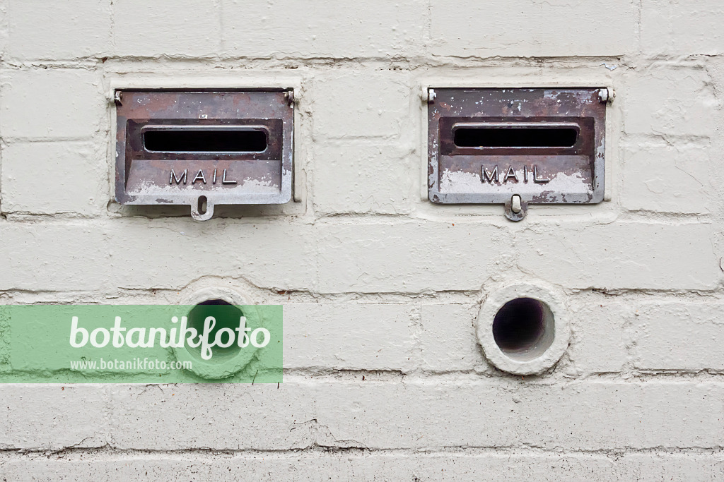 455207 - Mailboxes and newspaper tubes on a white brick wall, East Melbourne, Melbourne, Australia