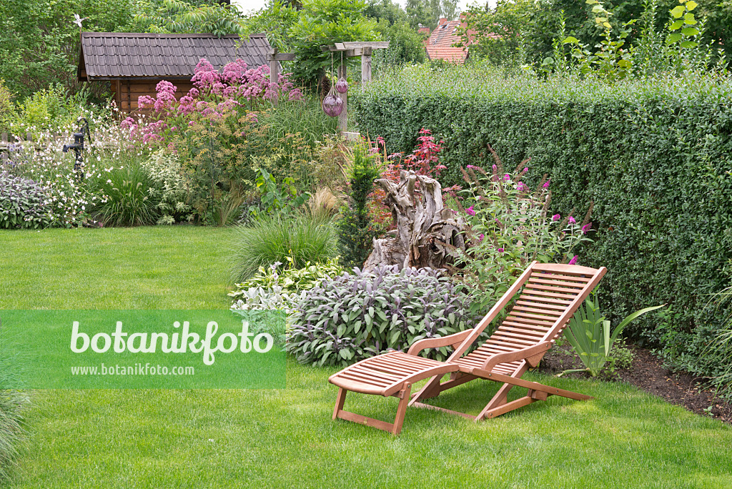 573064 - Perennial garden with deck chair