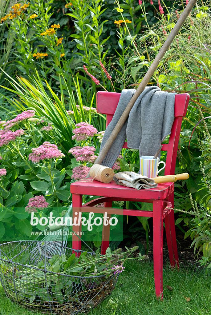 460002 - Red chair with gardening tools