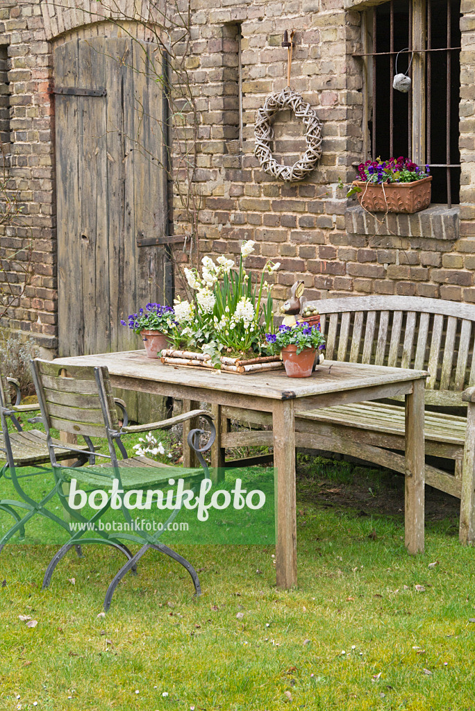 555012 - Seating area with spring decoration in front of a barn