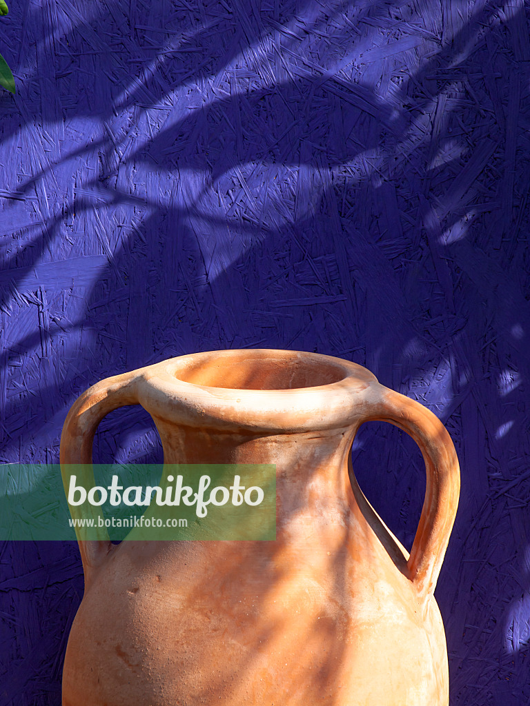 441176 - Stoneware jug in front of a blue wall