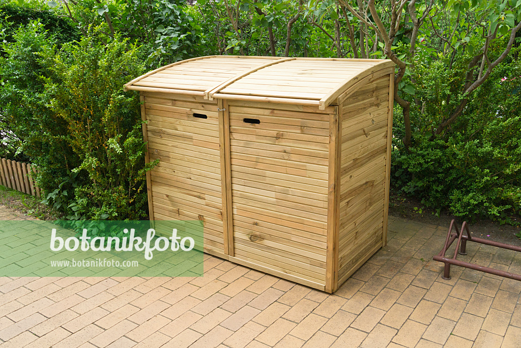 532031 - Trash bins with wooden lids on a terrace with stone tiles