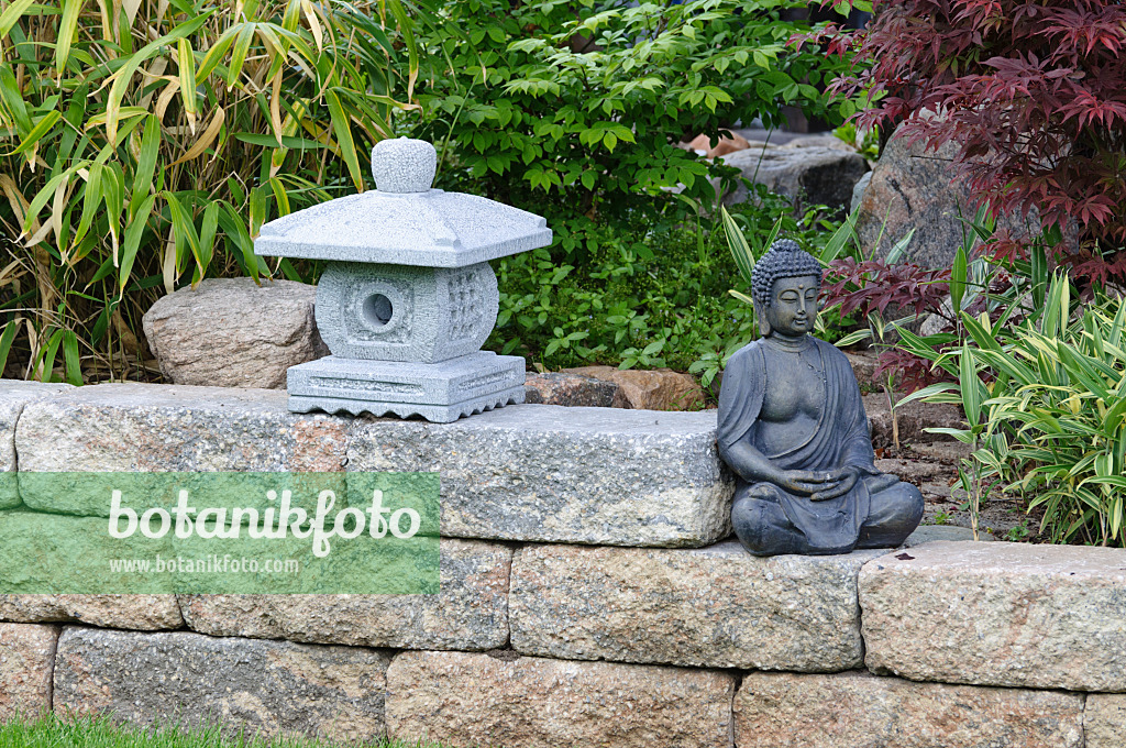 472356 - Wall with stone lantern and sitting Buddha