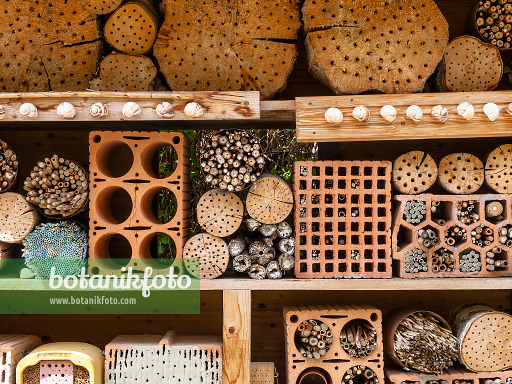 439202 - Nesting aid for bees and other insects with perforated bricks, tree trunks and branches in a wooden rack