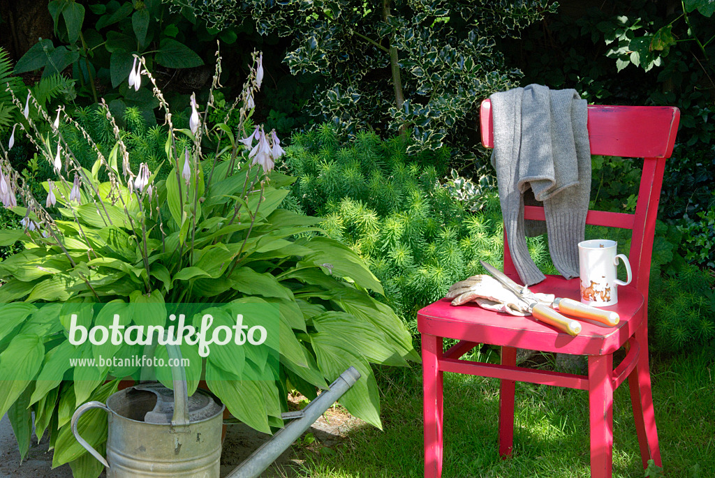 456003 - Red chair with gardening tools