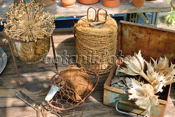 509151 - Workbench with dried flowers and rolls of binding twine