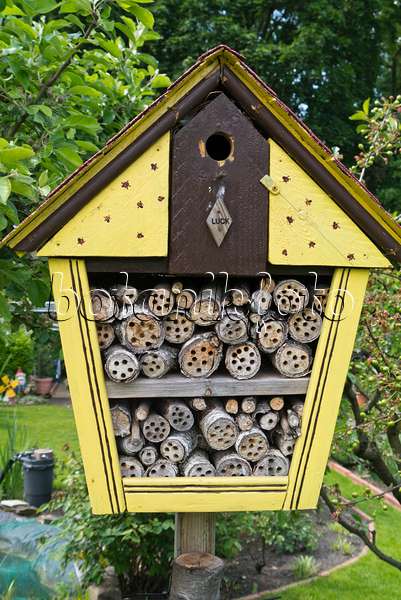 544168 - Yellow insect hotel with drilled branches