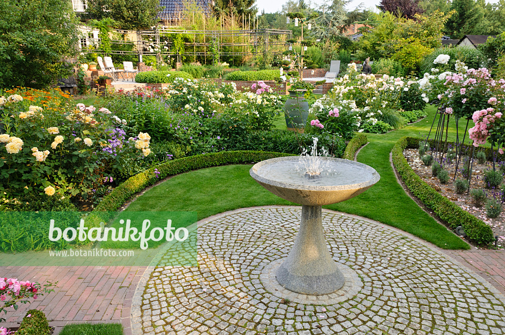 474071 - Granite fountain in a rose garden