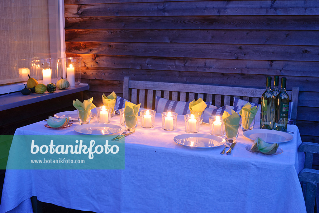 483035 - Laid table with candles on a terrace