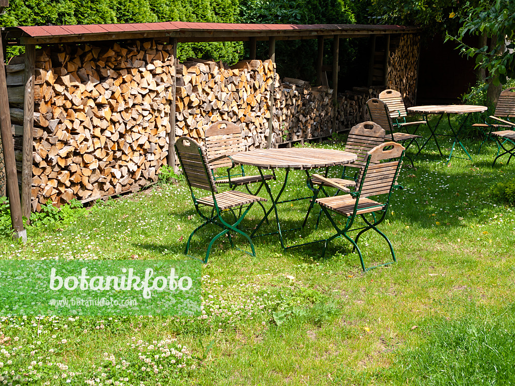 523251 - Pile de bois à côté d'un salon de jardin