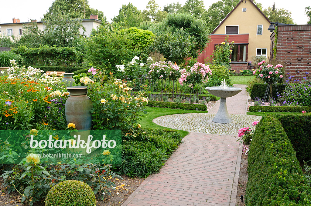 474076 - Rose garden with granite fountain and ceramic vase