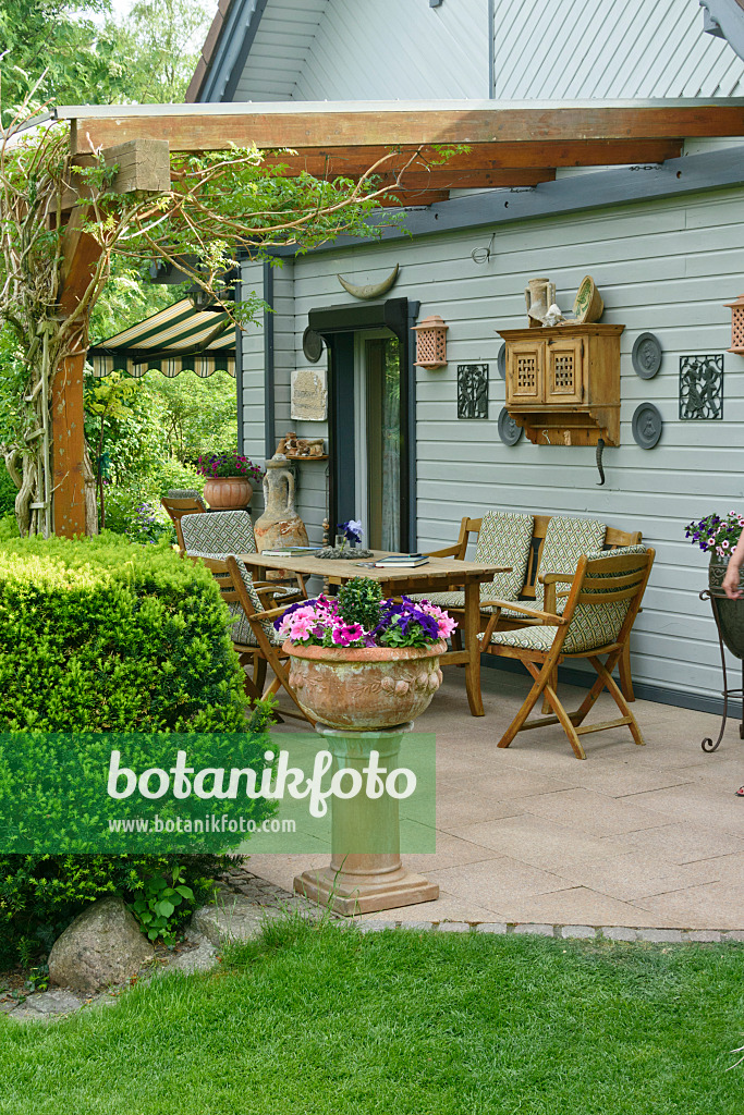 556066 - Seating area in front of a garden house