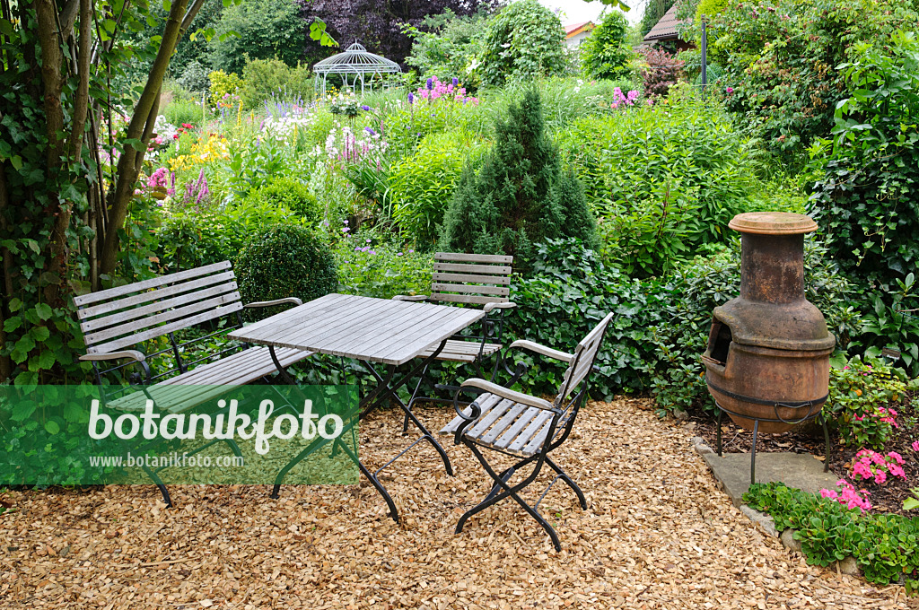 474083 - Seating area with Mexican oven in a perennial garden