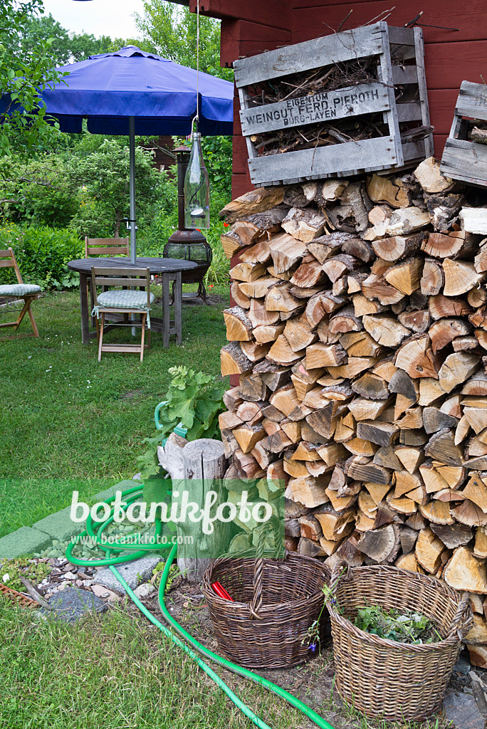557048 - Stack of wood in a natural garden