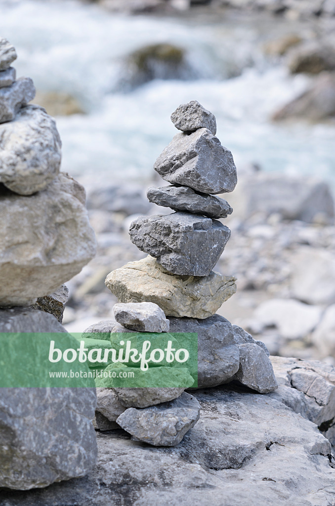 536084 - Stone pyramid at an Alpine brook
