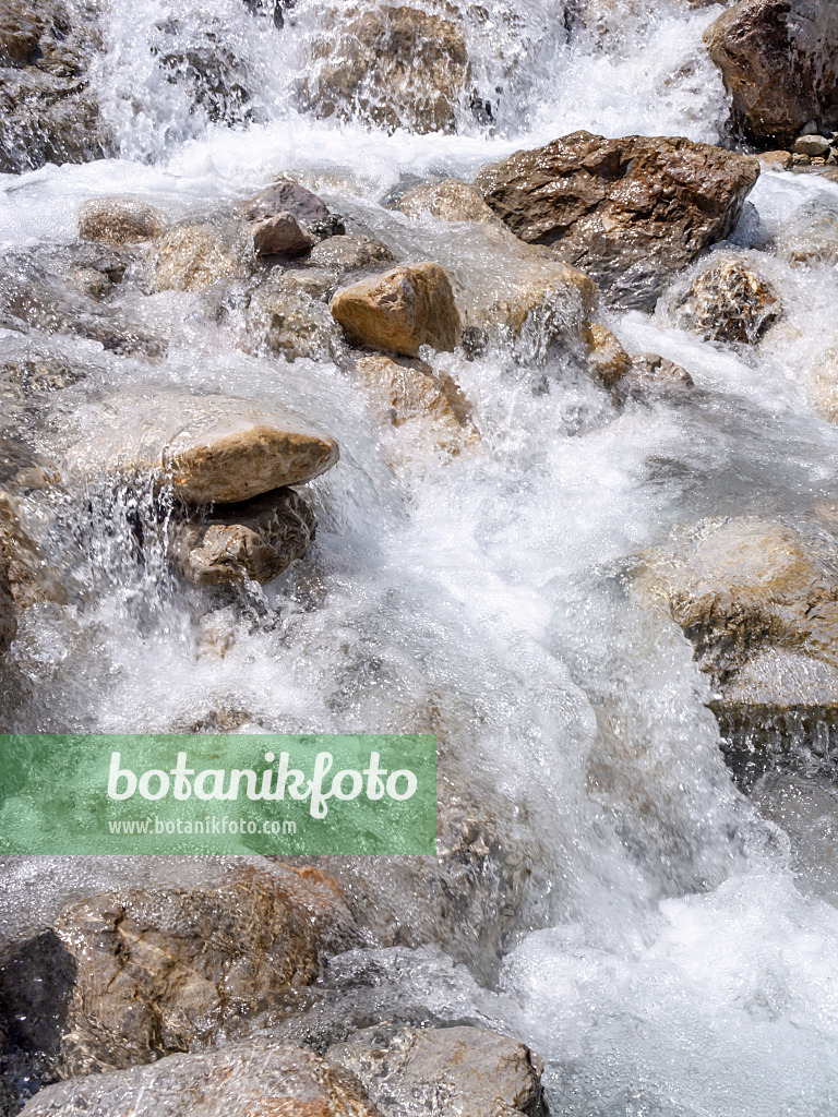 439143 - Wild foaming mountain stream crashing down between big stones