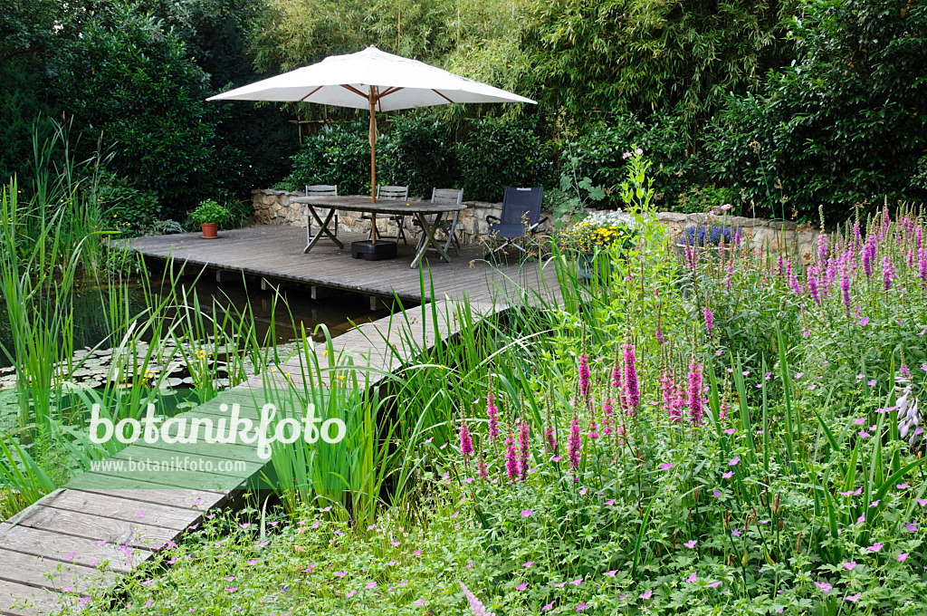 474048 - Wooden decking area with seats at a swimming pond