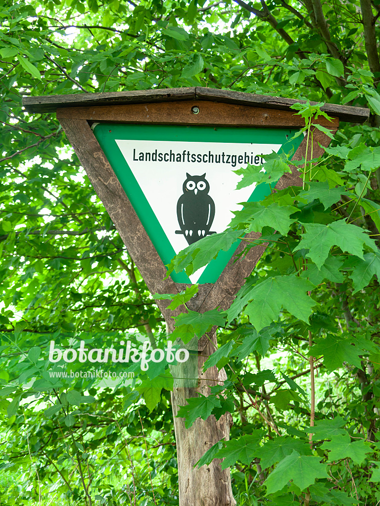 523247 - Wooden posts with signpost "Landschaftsschutzgebiet" and owl