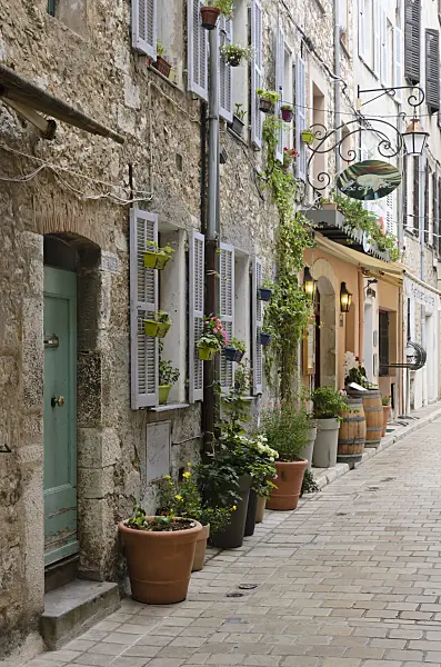 569089 - Alley with flower tubs in the old town, Vence, France