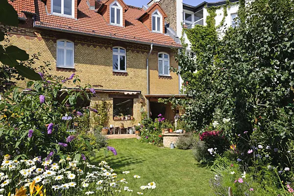 474346 - Backyard garden with perennial beds, lawn and terrace with potted plants