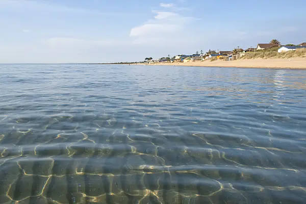 455195 - Beach with clear water and sun reflections at Port Phillip Bay, Frankston, Australia