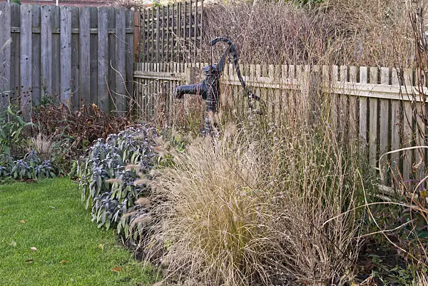 576031 - Beam pump in an autumnal perennial garden