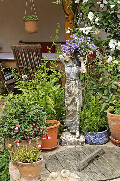 474371 - Bellflower (Campanula) with female figure on a cistern