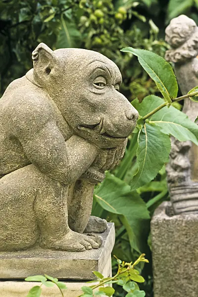 380071 - Bizarre stone garden sculpture of a squatting gargoyle