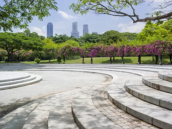 411051 - Bougainvillea behind a large square with stone stairs, Sundial Plaza, Marina City Park, Singapore