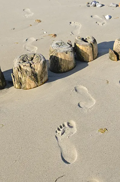 534327 - Breakwater with footprints in the sand