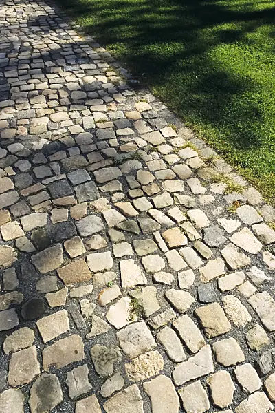 394070 - Cobblestones made of rough blocks in a park