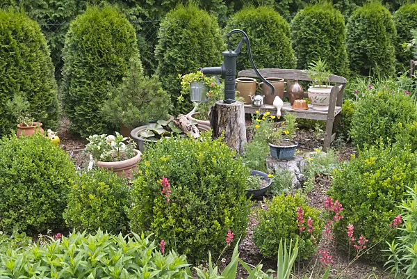 608138 - Garden bench with flower pots and beam pump