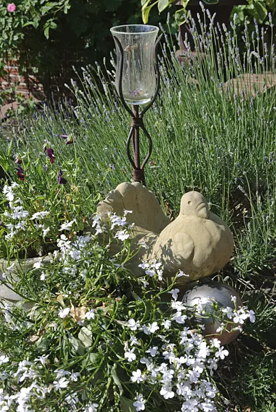 475263 - Garden decoration with terracotta bird and candle