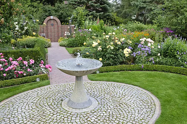 474054 - Granite fountain in a rose garden