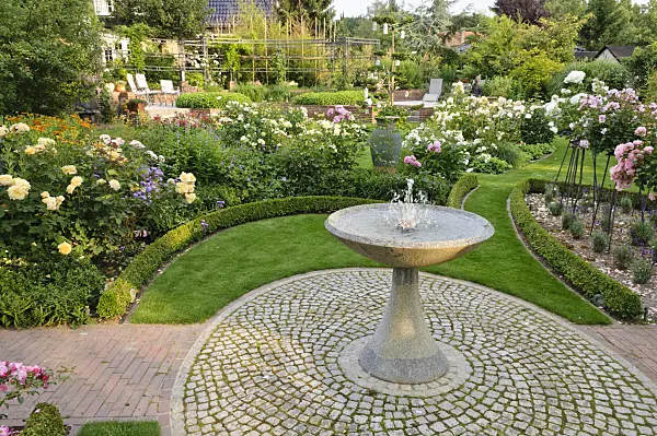 474071 - Granite fountain in a rose garden
