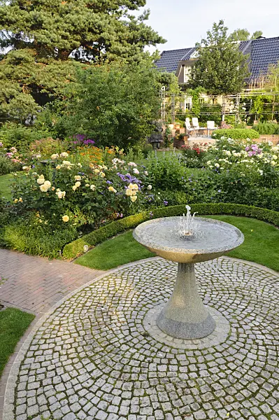 474072 - Granite fountain in a rose garden