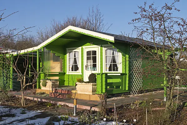 565050 - Green garden house in a wintery allotment garden