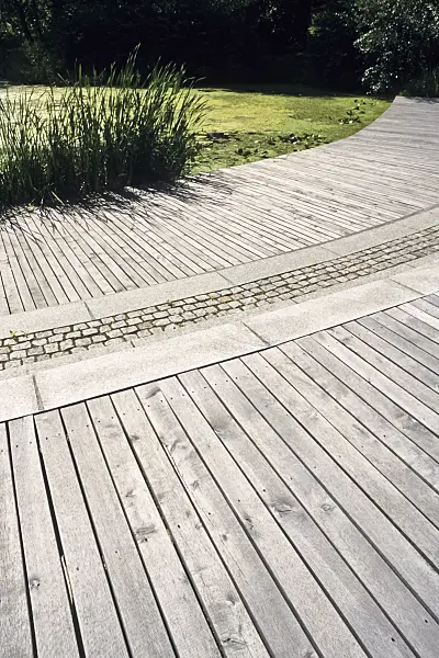 392046 - Large terrace with wooden slats and paving stones in front of an idyllic garden pond