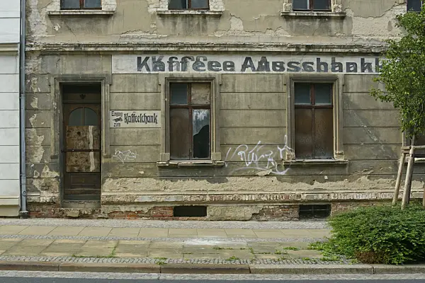 559061 - Old house from the founding period with old advertisement on the dilapidated house wall, Görlitz, Germany