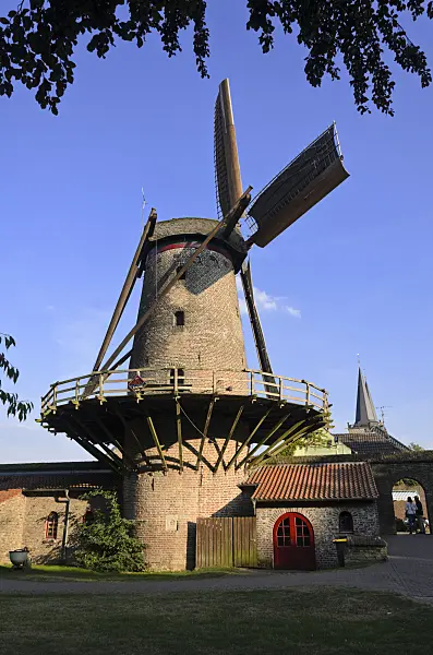 560036 - Old windmill in the sunlight in front of a blue sky in Xanten, Germany