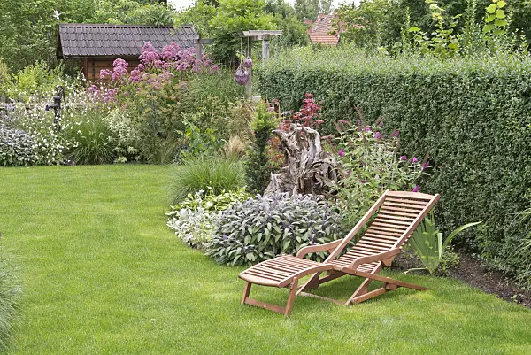 573064 - Perennial garden with deck chair
