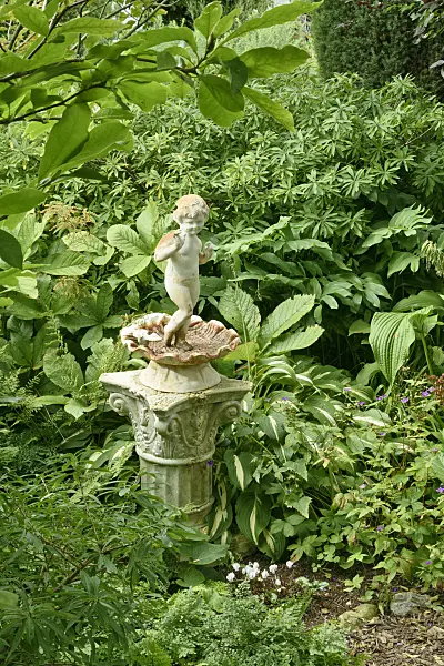 559080 - Sculpture in a perennial garden