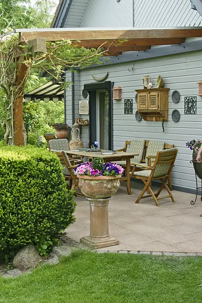 556066 - Seating area in front of a garden house