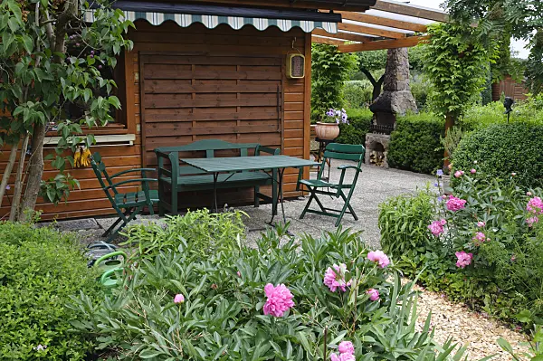 473114 - Seating area in front of a wooden house